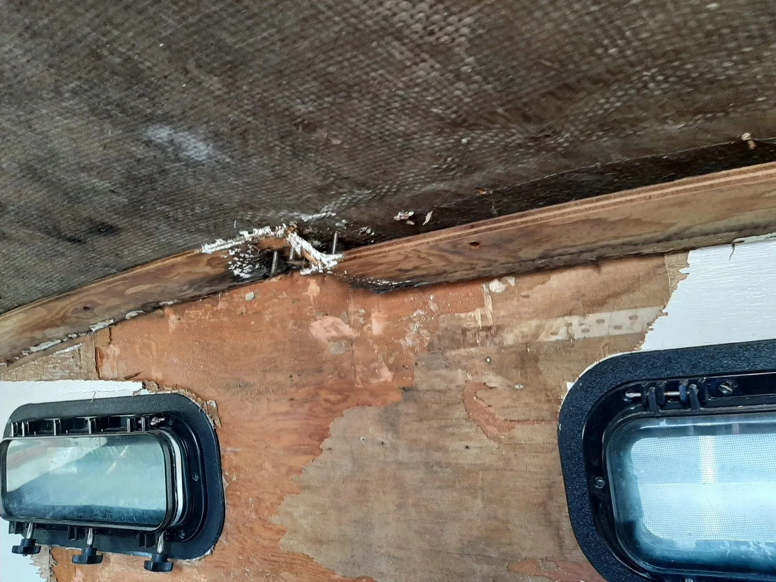 A boat cabin stripped back showing water damage