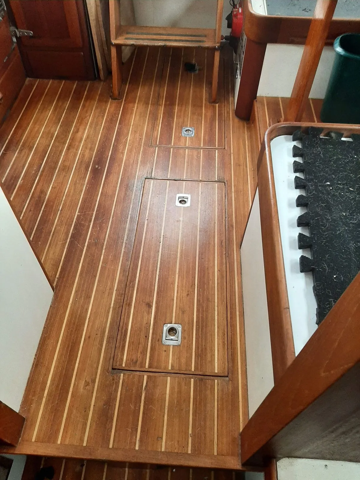 A restored teak deck with caulked seams