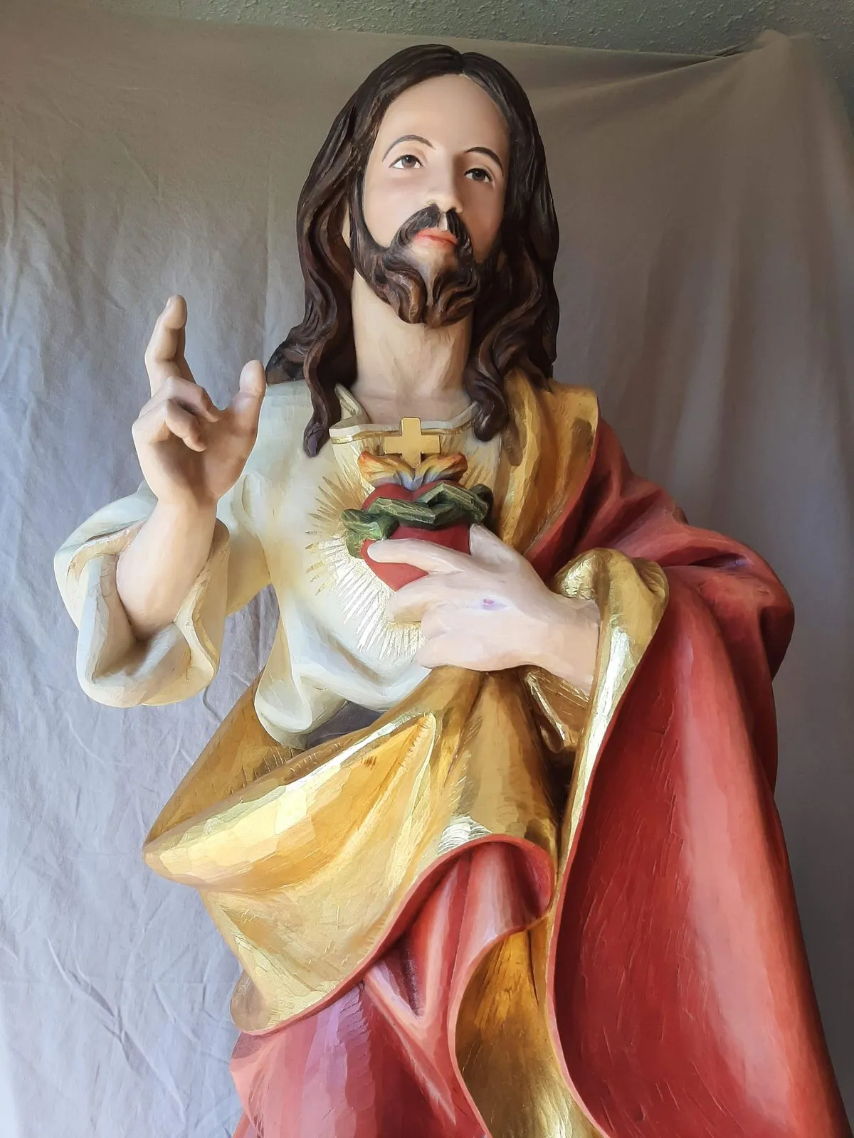 The finished polychrome statue, repainted with a gilded robe