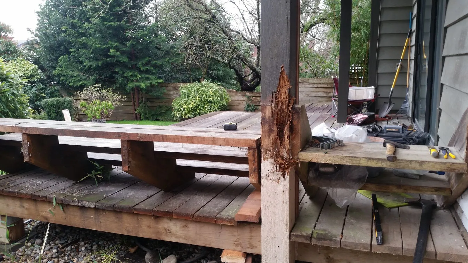 A rotten deck with failed boards and a decayed support post