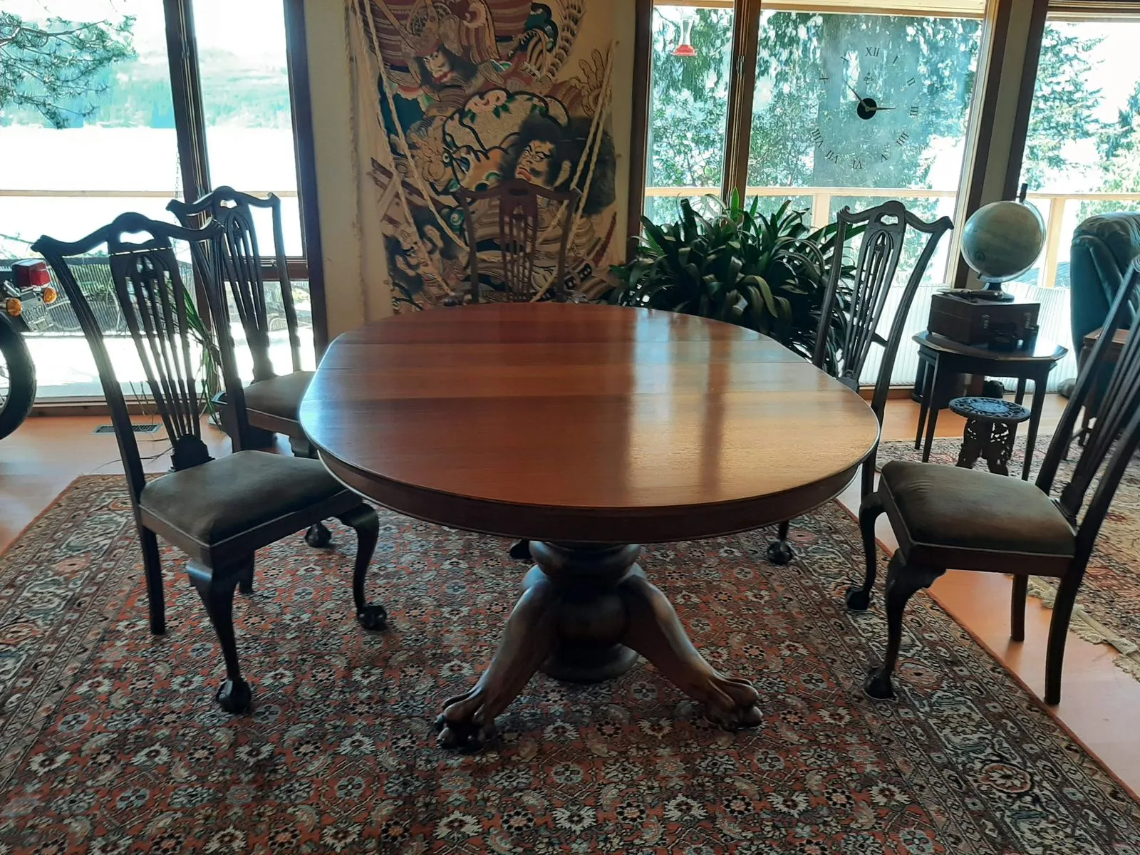 A restored pedestal dining table with ball and claw feet