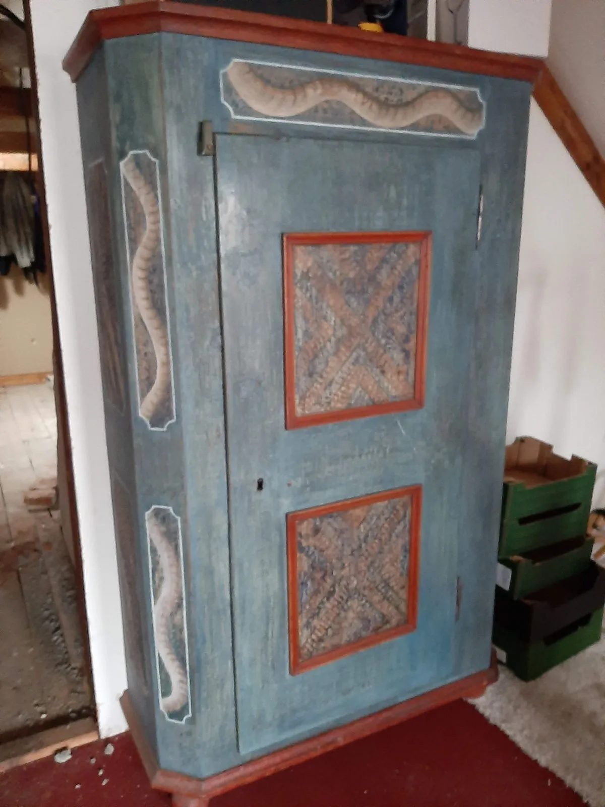 A painted antique cabinet with marbled panels
