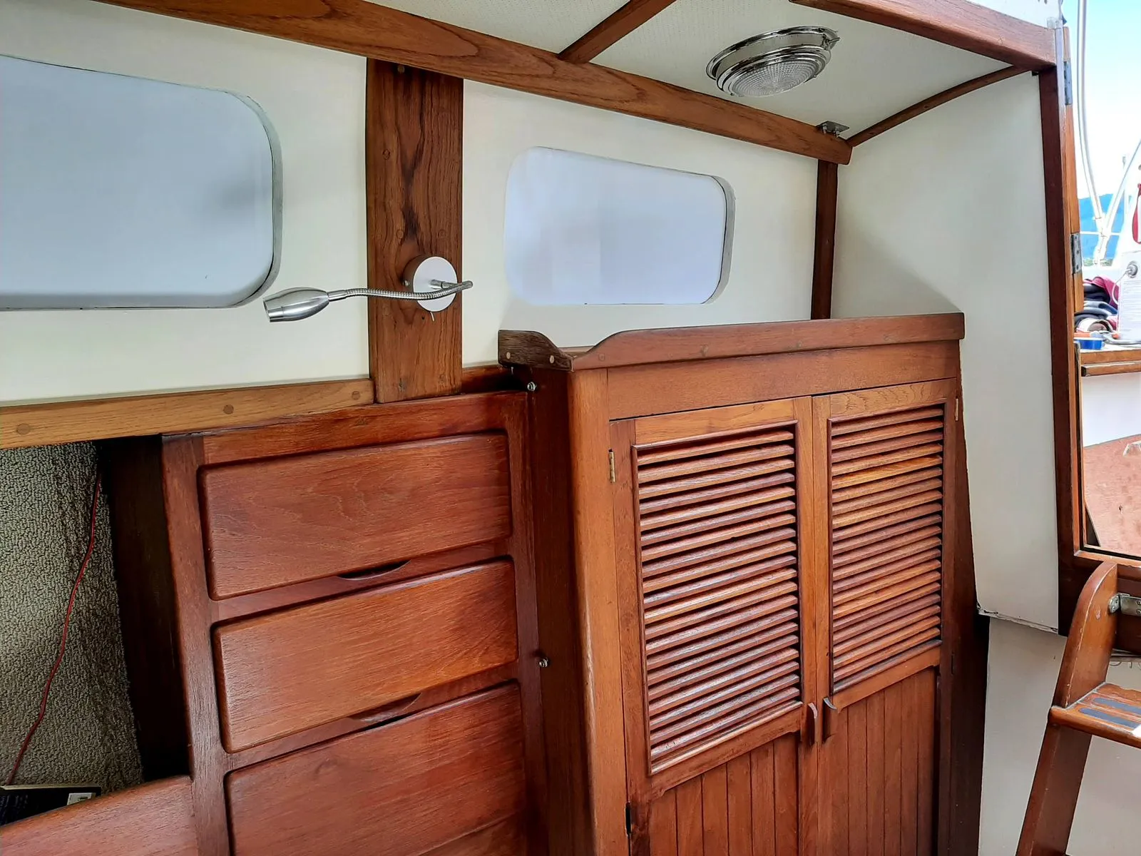 A finished boat cabin lined in restored teak joinery